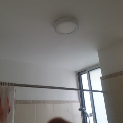 תקרה צבועה בלבן עם מנורה עגולה