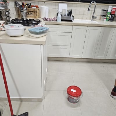 דלי צבע על רצפת מטבח עם מגב