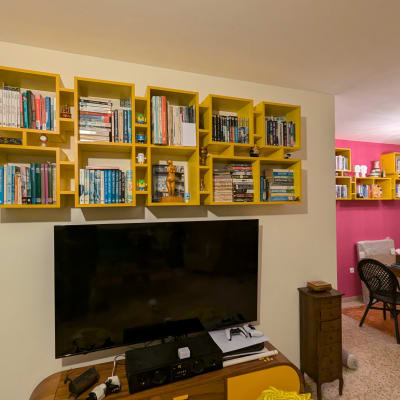 מדפי ספרים צהובים תלויים על הקיר