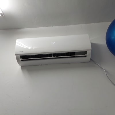 מזגן קיר לבן עם תצוגת טמפרטורה