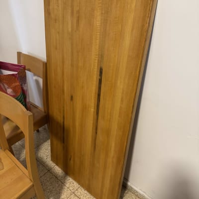 לוח עץ עומד ליד כיסא על רצפה