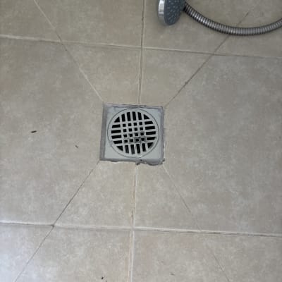 ראש מקלחת ורצפת קרמיקה עם ניקוז