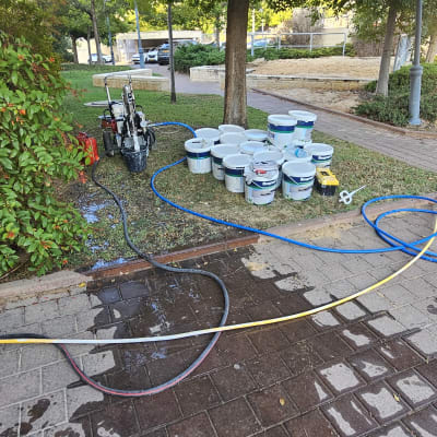 דלי צבעים וכלי עבודה על דשא, חוטים וצינורות