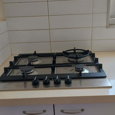 כיריים גז עם ארבעה מבערים וכפתורי שליטה