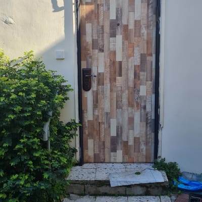 דלת מצופה בעיצוב עץ עם ידית מתכת כהה