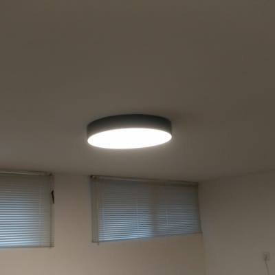 מנורת תקרה עגולה דולקת על תקרה לבנה