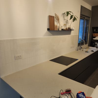 שיש מטבח עם כלים וחפצים שונים על השיש