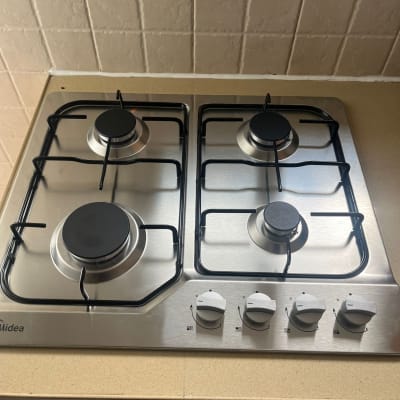 כיריים גז עם ארבעה מבערים וכפתורי שליטה