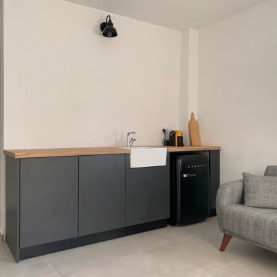 מטבח עם כיור, מקרר קטן ומכונת קפה על השיש