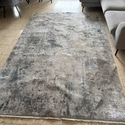 שטיח אפור על רצפה ליד ספה אפורה