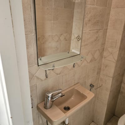 כיור ומראה בחדר אמבטיה עם אריחים נקיים