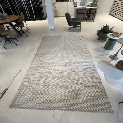 שטיח בהיר על רצפה עם כתמים קלים