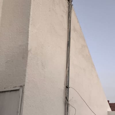 קיר חיצוני עם אנטנה וכבלים מחוברים