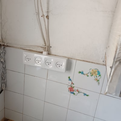 שקעי חשמל על קיר עם אריחים פרחוניים