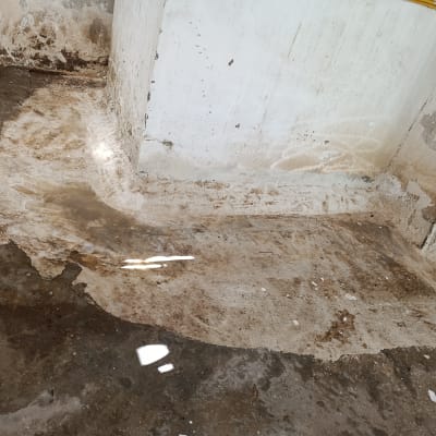 רצפה מלוכלכת עם כתמי מים ולכלוך בפינה