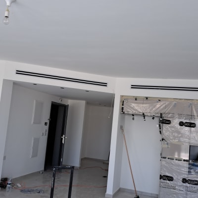 קירות גבס לבנים עם פתחי מיזוג אוויר