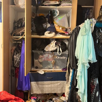 ארון בגדים פתוח עם בגדים ופריטים שונים מבולגנים