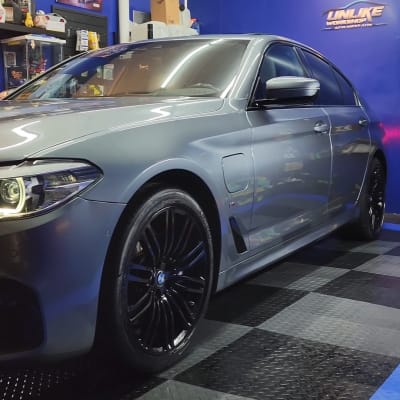 מכונית אפורה עם גלגלים שחורים בסדנה כחולה