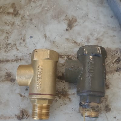 שני שסתומים מונחים על שולחן עבודה מלוכלך