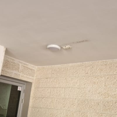 תאורה מותקנת על תקרה ליד קיר אבן