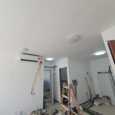 סולם, דלי צבע, קירות בתהליך שיפוץ, חוטי חשמל חשופים