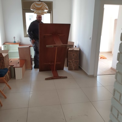 אדם בחדר עם רהיטים וכלי עבודה