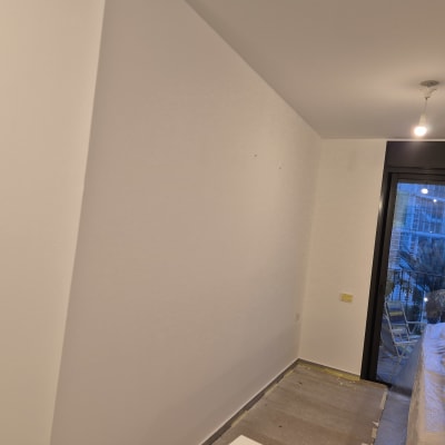 חדר צבוע עם קיר לבן ותאורה עליונה