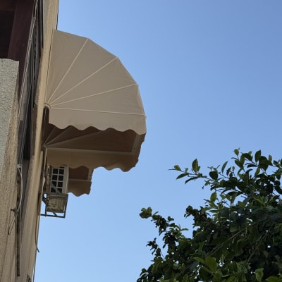 סוכך חיצוני על קיר בניין עם שמיים כחולים