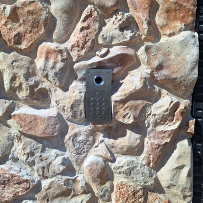 אינטרקום מתכתי מותקן על קיר אבן