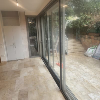 רצפה נקייה עם חלונות זכוכית גדולים ומטאטא אדום