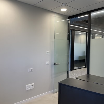 קיר צבוע במשרד עם דלת זכוכית ושולחן