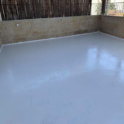 רצפה אטומה בלבן עם קירות אבן מסביב