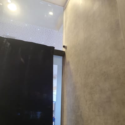 מצלמת אבטחה מותקנת בפינת תקרה ליד וילון שחור