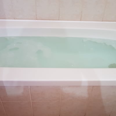 אמבטיה מלאה במים עם קצף קל על פני השטח