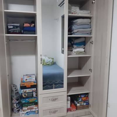 ארון בגדים עם מדפים, בגדים מקופלים ומשחקי קופסה