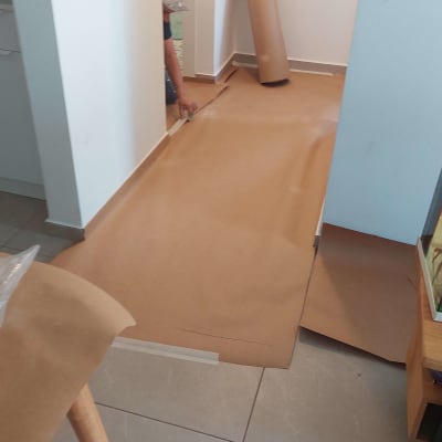 רצפה מכוסה בנייר חום להגנה בזמן צביעה