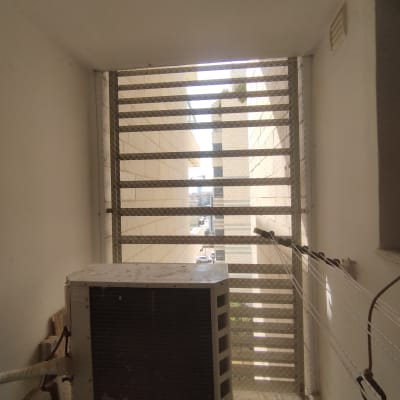 רשת מתכת על חלון למניעת כניסת יונים