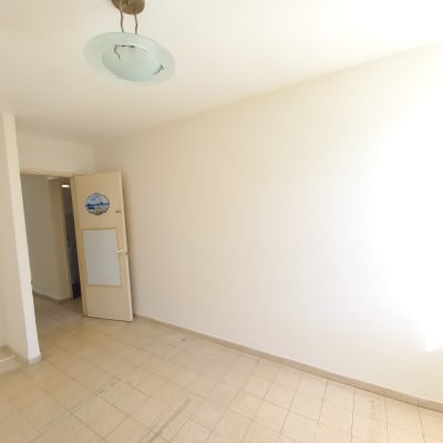 קיר צבוע בלבן בחדר ריק עם דלת פתוחה