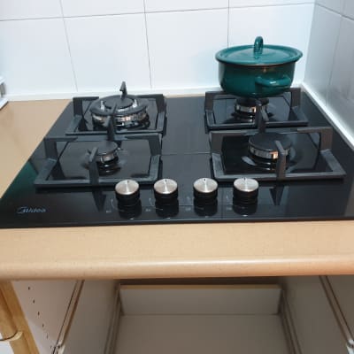 כיריים גז עם סיר ירוק על הכיריים