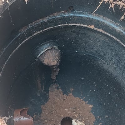 צינור שבור בתוך בור עם אדמה