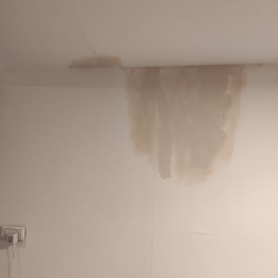 כתם רטיבות על תקרה וקיר לבן