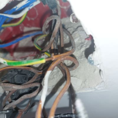 חוטי חשמל צבעוניים בתוך קיר עם חיבורים חשמליים