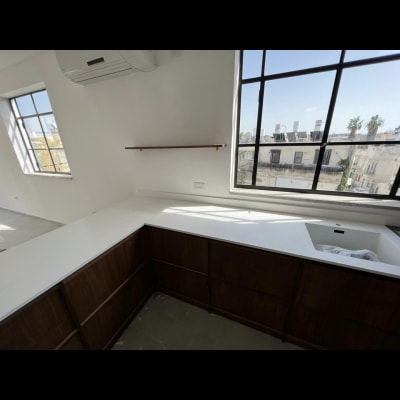 משטח שיש לבן במטבח עם כיור מובנה