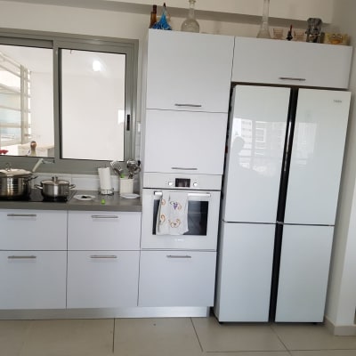 מטבח מודרני עם מקרר, תנור וסירים על הכיריים