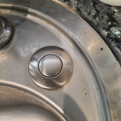 כפתור מתכת עגול בכיור נירוסטה