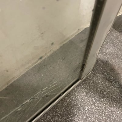 זכוכית עם שריטות במסגרת מתכת ליד מדרגות