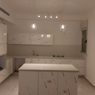 שני גופי תאורה תלויים מעל אי במטבח