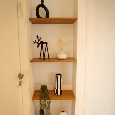 מדפים מעץ עם אגרטלים ודקורציות מודרניות