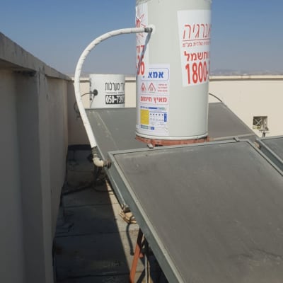 דוד שמש עם צינור על גג מבנה