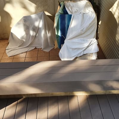 wooden bench on tiled floor with covered items